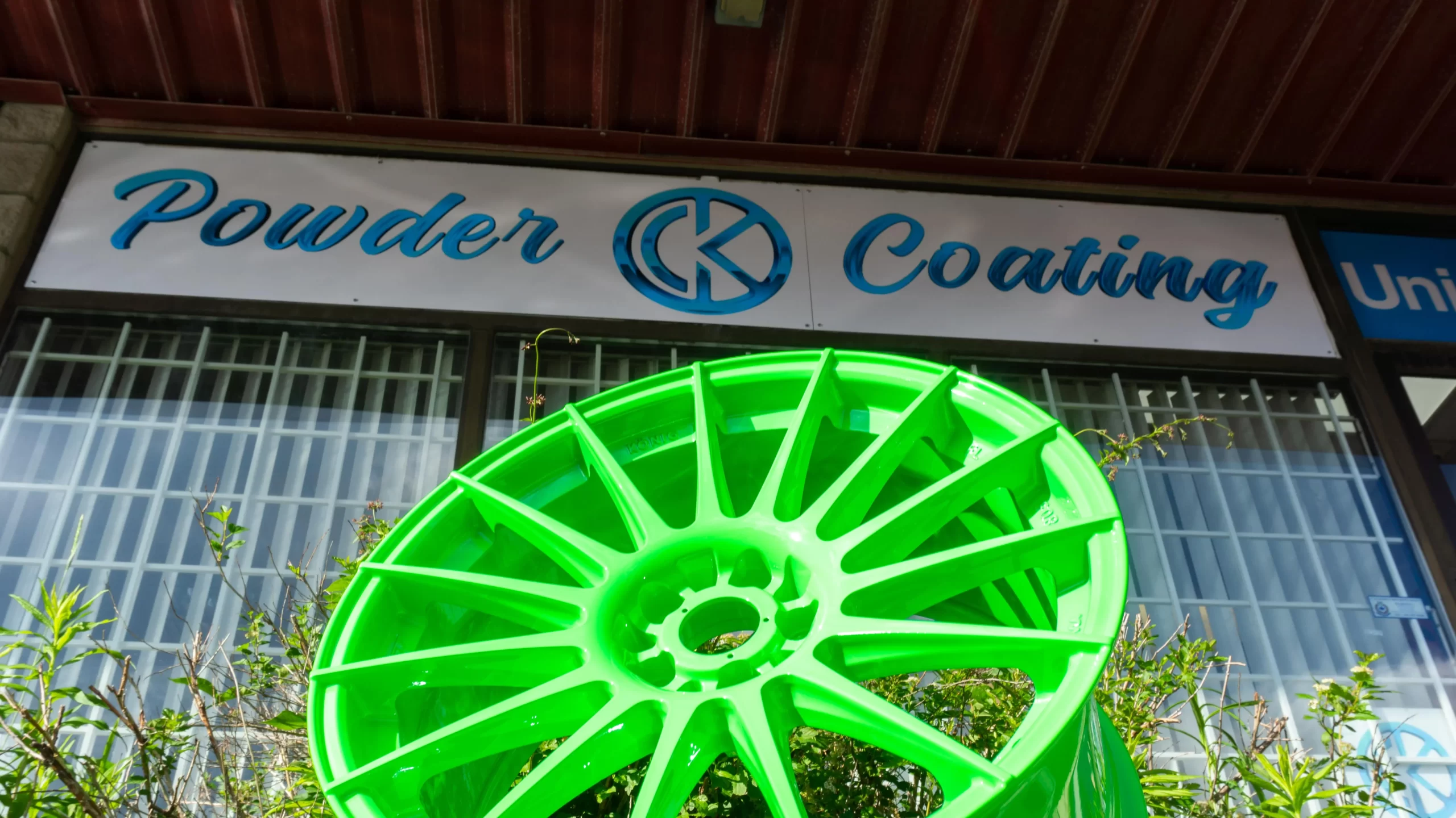 neon green powder coated wheel sitting on top of a tire